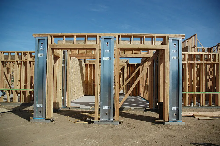 Timber wall frames with steel posts going up on site